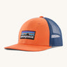 Patagonia kids trucker hat in orange peel . Showing the vibrant orange front panel with matching bill and blue mesh on the back.  Features a brand patch on the front panel.