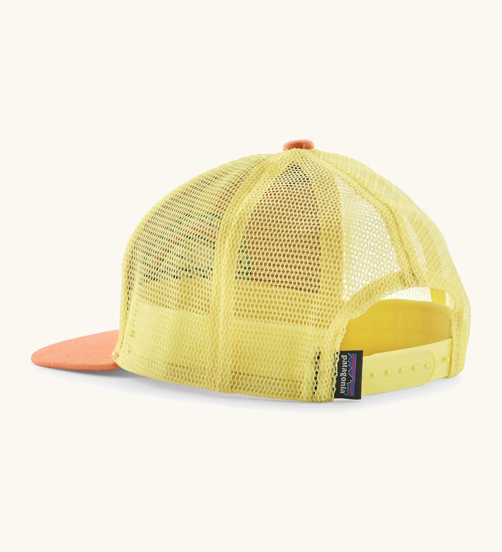Patagonia kid's trucker hat in orange with yellow mesh on the back. Showing adjustable size strap