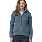 A woman wearing a Patagonia Women's Better Sweater Jacket Utility Blue stood in front of a plain background