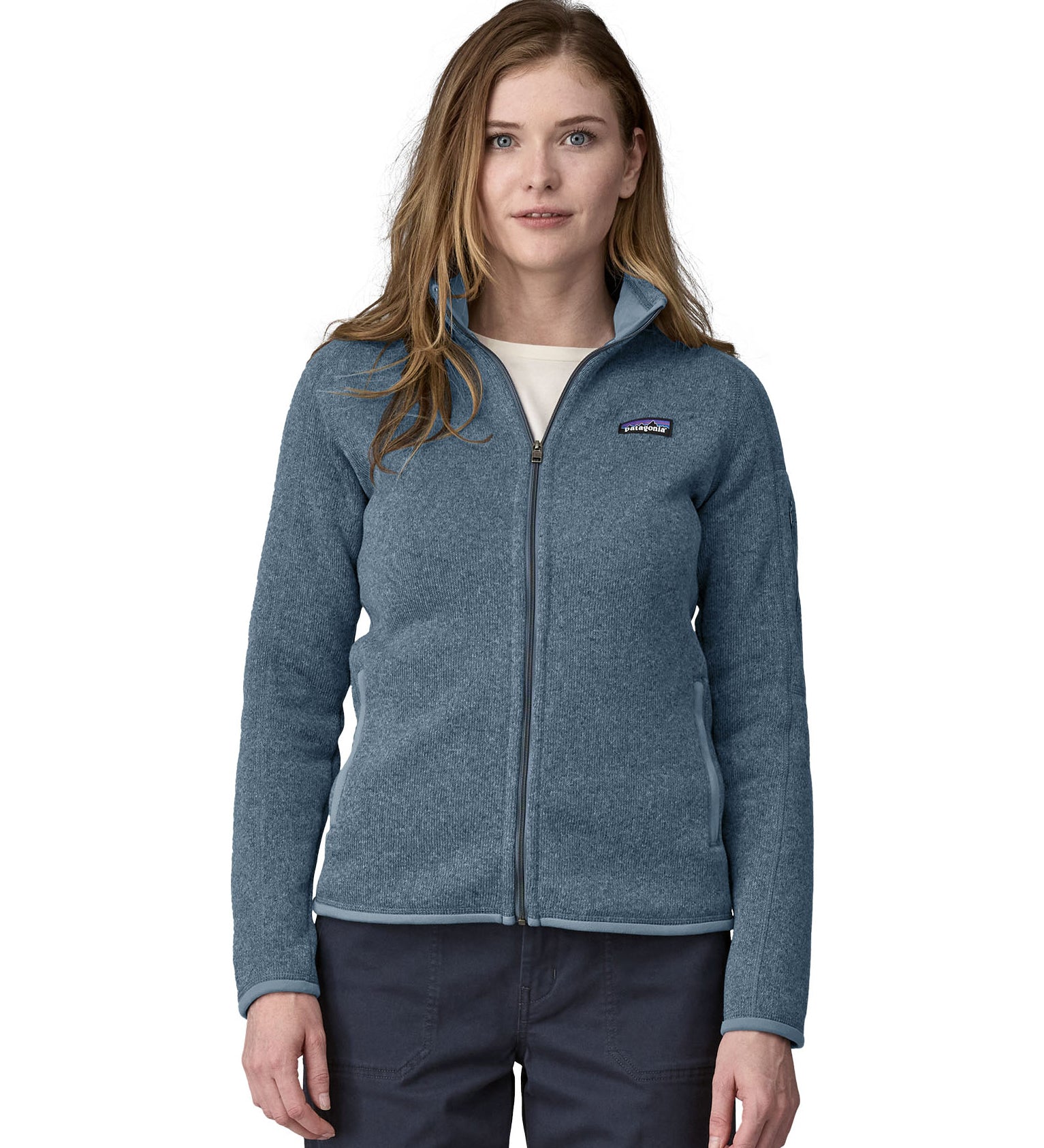 A woman wearing a Patagonia Women's Better Sweater Jacket Utility Blue stood in front of a plain background