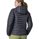 A woman wearing a Patagonia Women's Down Sweater Hoody in a Smolder Blue colour. The woman is facing away, showing the back of the coat. 
