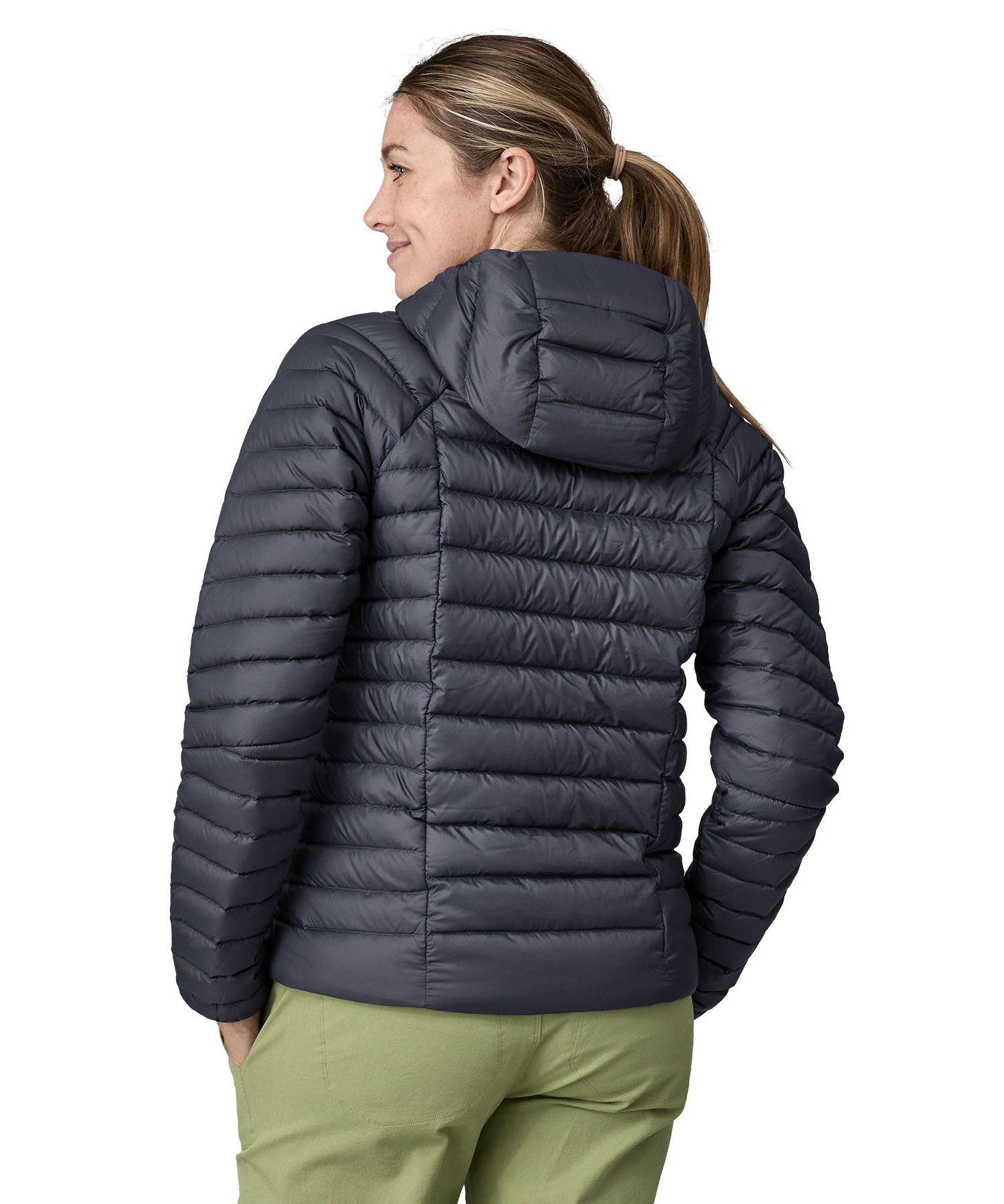 A woman wearing a Patagonia Women's Down Sweater Hoody in a Smolder Blue colour. The woman is facing away, showing the back of the coat. 