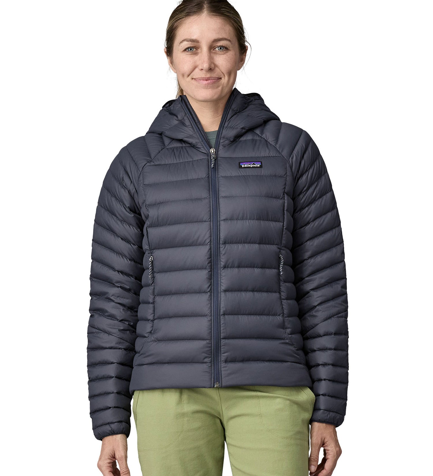 A woman wearing a Patagonia Women's Down Sweater Hoody in a Smolder Blue colour.