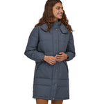 A woman wearing a Patagonia Women's Downdrift Parka Pine Smolder Blue