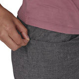 Patagonia women's hampi rock pants in regular ink black being worn, a close up of a hand reaching into a front pocket.