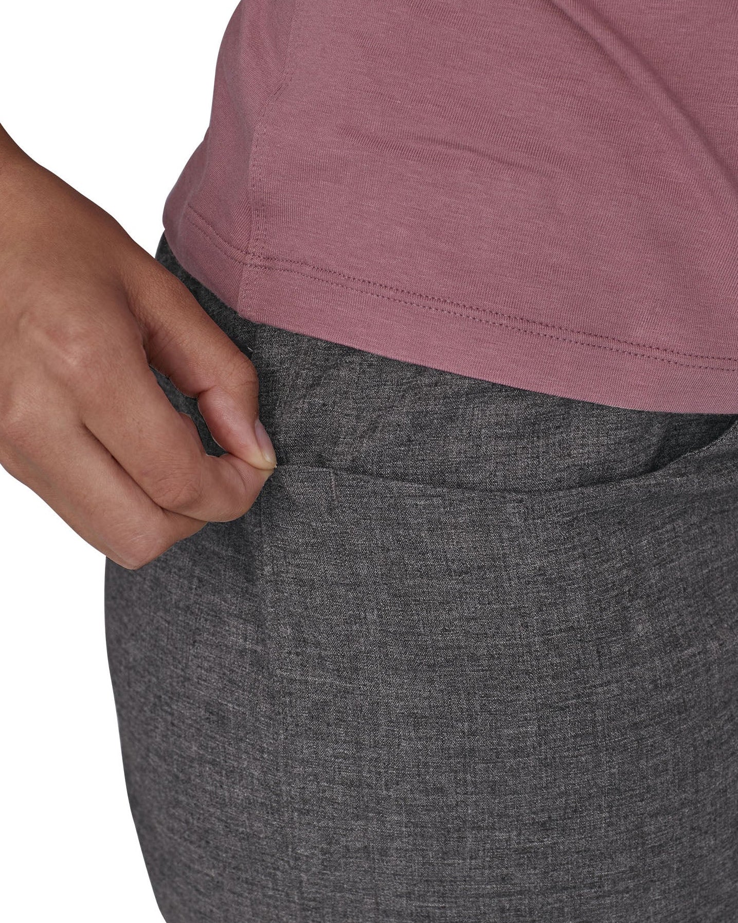 Patagonia women's hampi rock pants in regular ink black being worn, a close up of a hand reaching into a front pocket.