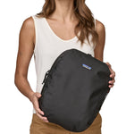 Patagonia large cube travel bag held by an adult