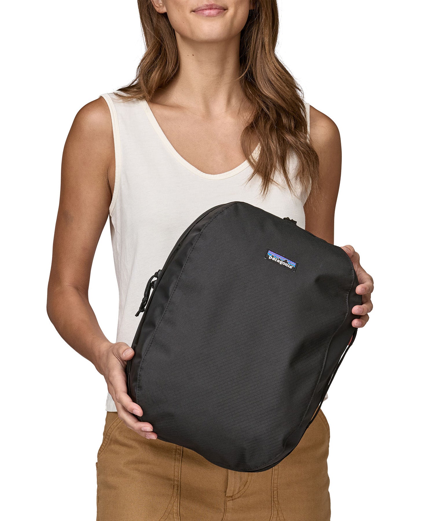 Patagonia large cube travel bag held by an adult