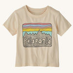 The Patagonia Little Kids Regenerative Fitz Roy Skies T-Shirt in a Undyed Natural colour way on a plain background. 