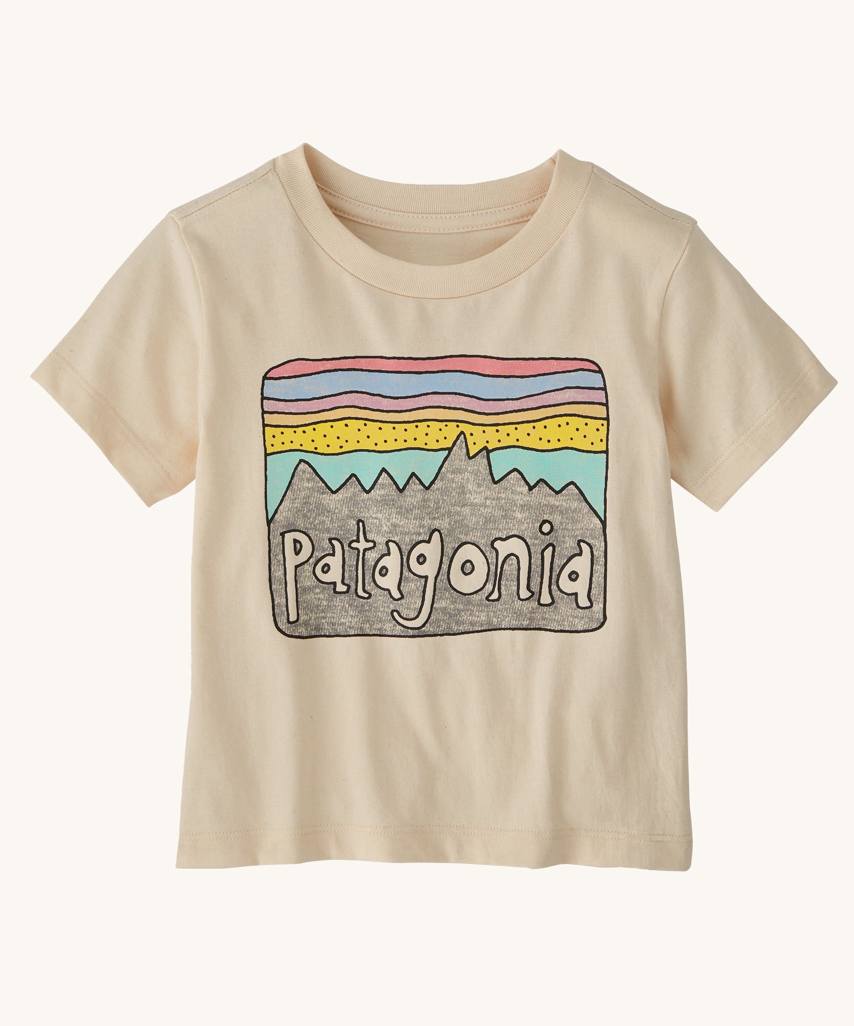 The Patagonia Little Kids Regenerative Fitz Roy Skies T-Shirt in a Undyed Natural colour way on a plain background. 