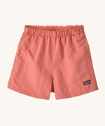The Patagonia Little Kids Baggies Shorts in Peak Pink colour way on a plain background. 