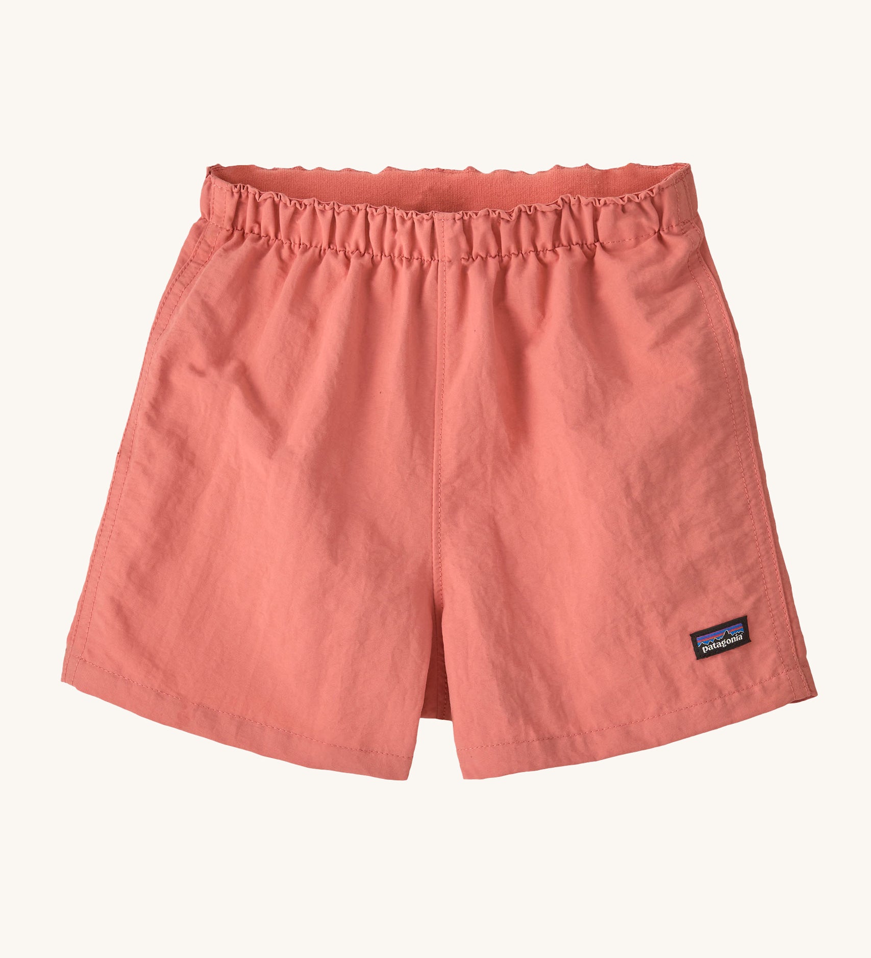 The Patagonia Little Kids Baggies Shorts in Peak Pink colour way on a plain background. 