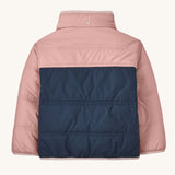 The back of a Patagonia Little Kids Reversible Tribbles Hoody shown with the hood off. Shown in a pink colour way