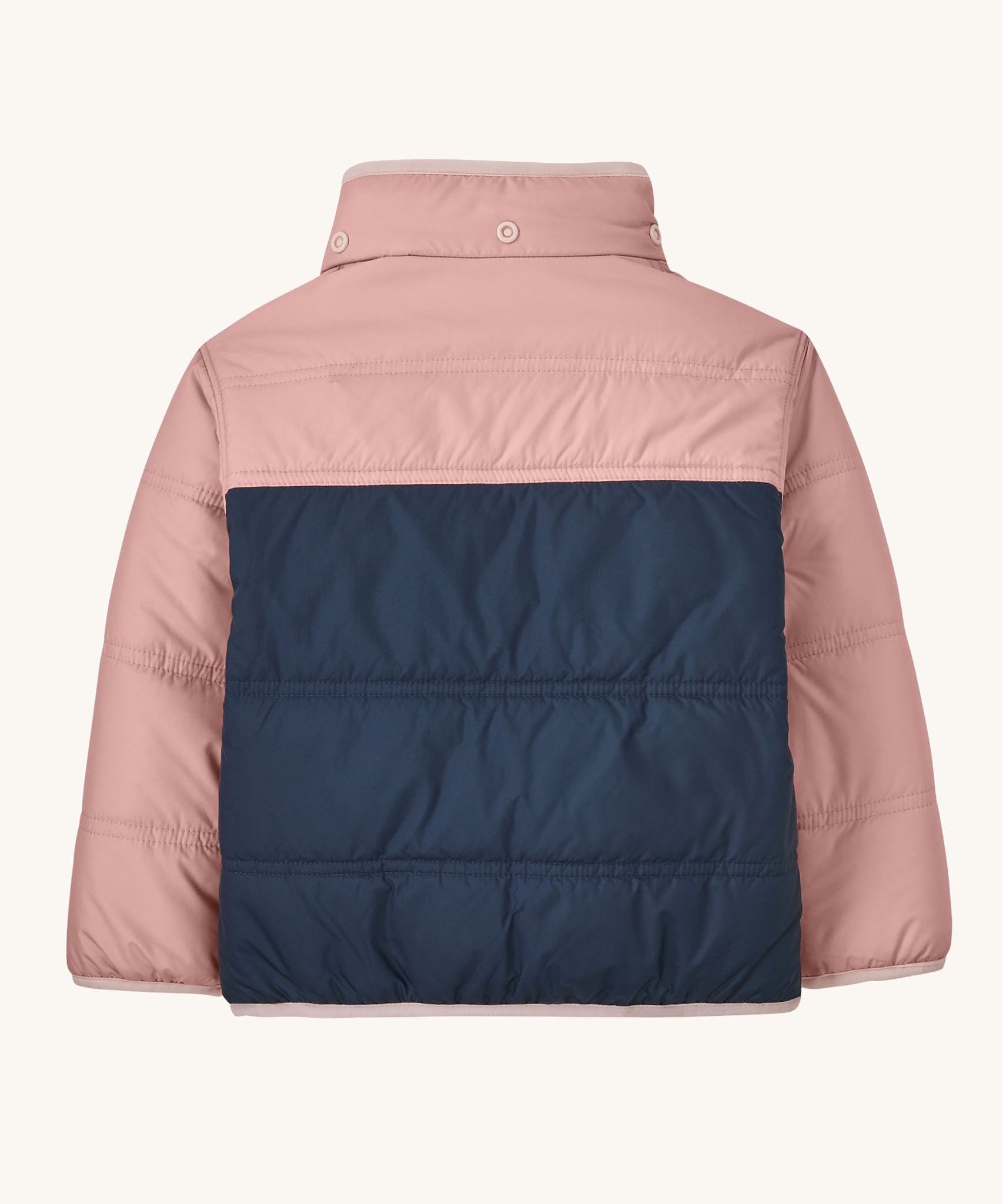 The back of a Patagonia Little Kids Reversible Tribbles Hoody shown with the hood off. Shown in a pink colour way