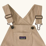 Patagonia Little Kids Stand Up Shortall dungarees in an dark cream showing small pouch chest pocket and hook & loop buckles
