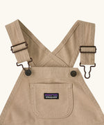 Patagonia Little Kids Stand Up Shortall dungarees in an dark cream showing small pouch chest pocket and hook & loop buckles