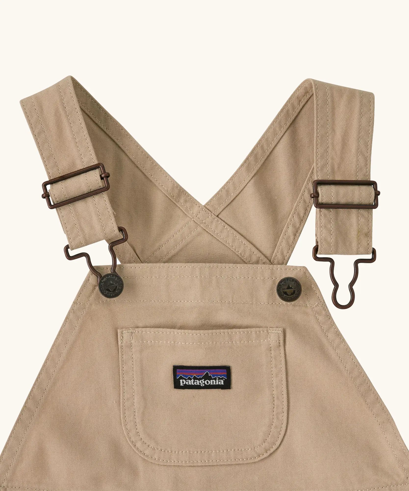 Patagonia Little Kids Stand Up Shortall dungarees in an dark cream showing small pouch chest pocket and hook & loop buckles