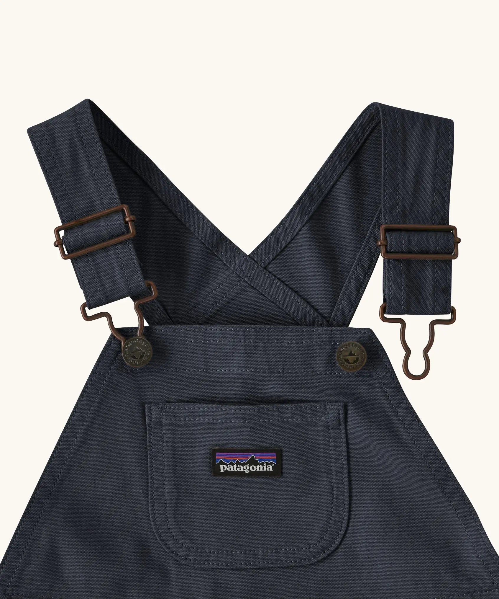 Patagonia Little Kids Stand Up Shortall dungarees in an navy showing small pouch chest pocket and hook & loop buckles