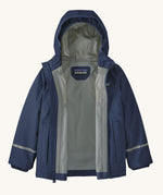 The Patagonia Little Kids Torrentshell 3L Waterproof Jacket in a New Navy colour on a plain background. The jacket's zip is fullt open showing the grey coloured lining. 