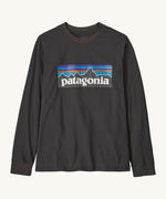 Patagonia organic cotton kids long sleeve t-shirt in black. Features a large logo print on the front panel. 