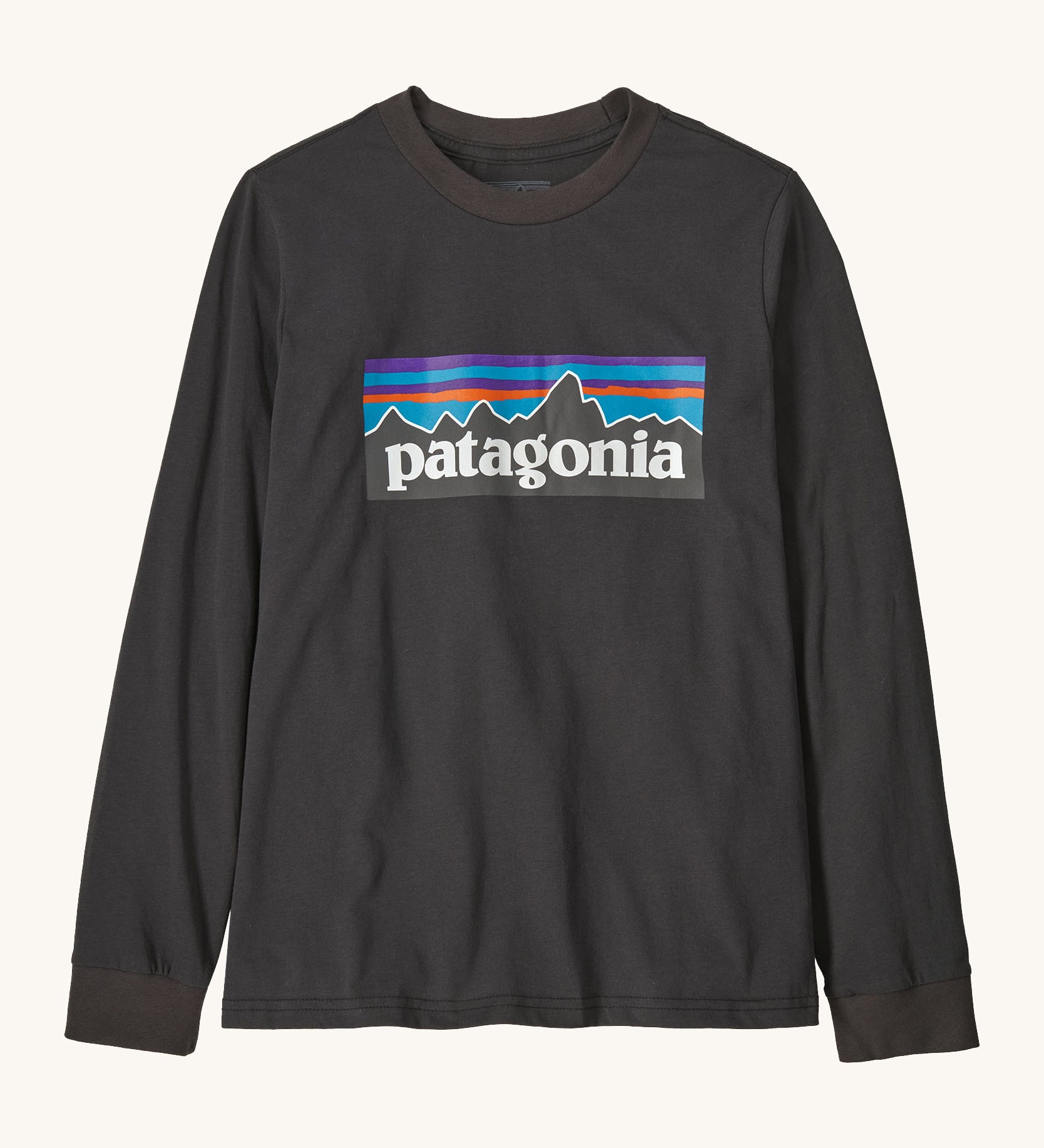 Patagonia organic cotton kids long sleeve t-shirt in black. Features a large logo print on the front panel. 