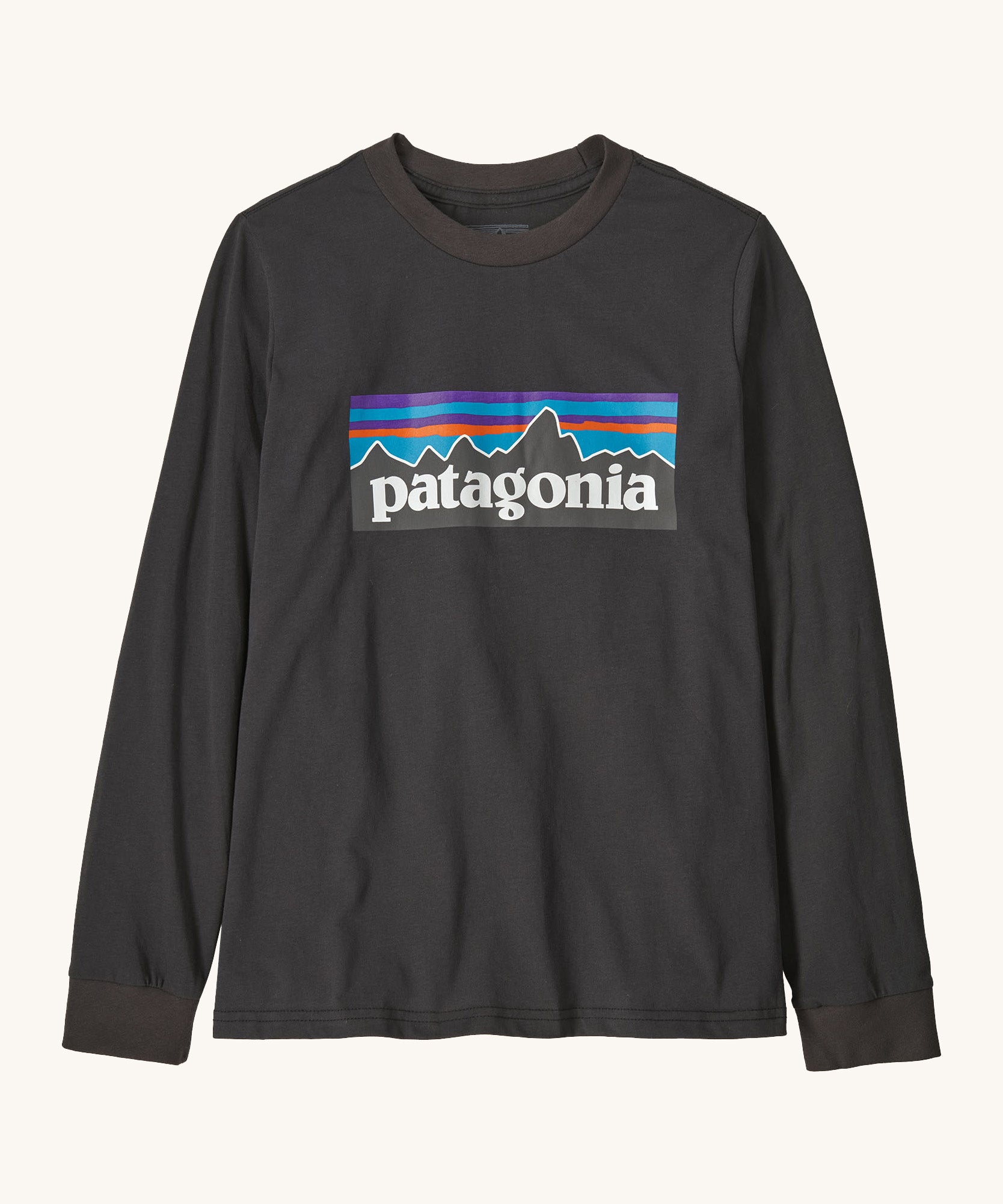 Patagonia organic cotton kids long sleeve t-shirt in black. Features a large logo print on the front panel. 