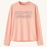 Patagonia kids long sleeve tshirt in a light pink colour with logo outline on a cream background.