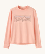 Patagonia kids long sleeve tshirt in a light pink colour with logo outline on a cream background.