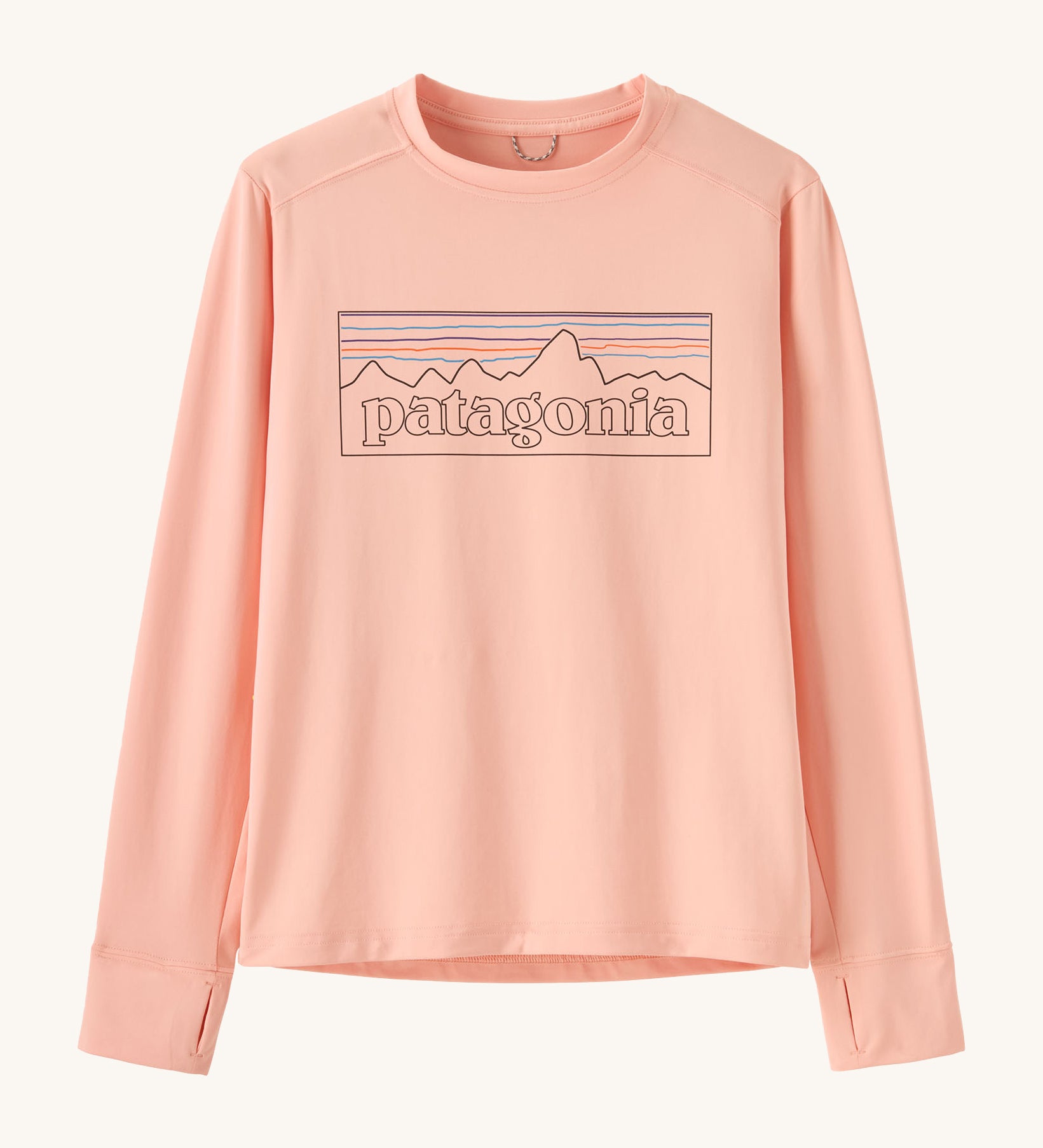 Patagonia kids long sleeve tshirt in a light pink colour with logo outline on a cream background.