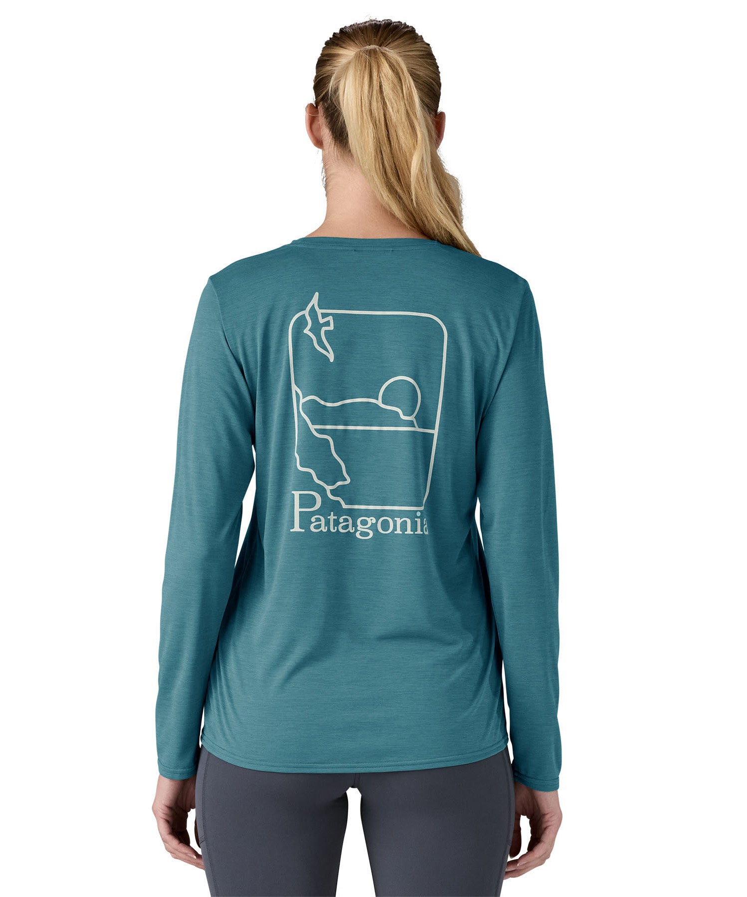 Patagonia women's long sleeve capilene top in turquoise beach outline design worn by a woman