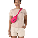 Patagonia Terravia Mini Hip Pack in a  luminous pink colour worn by an adult on the shoulder
