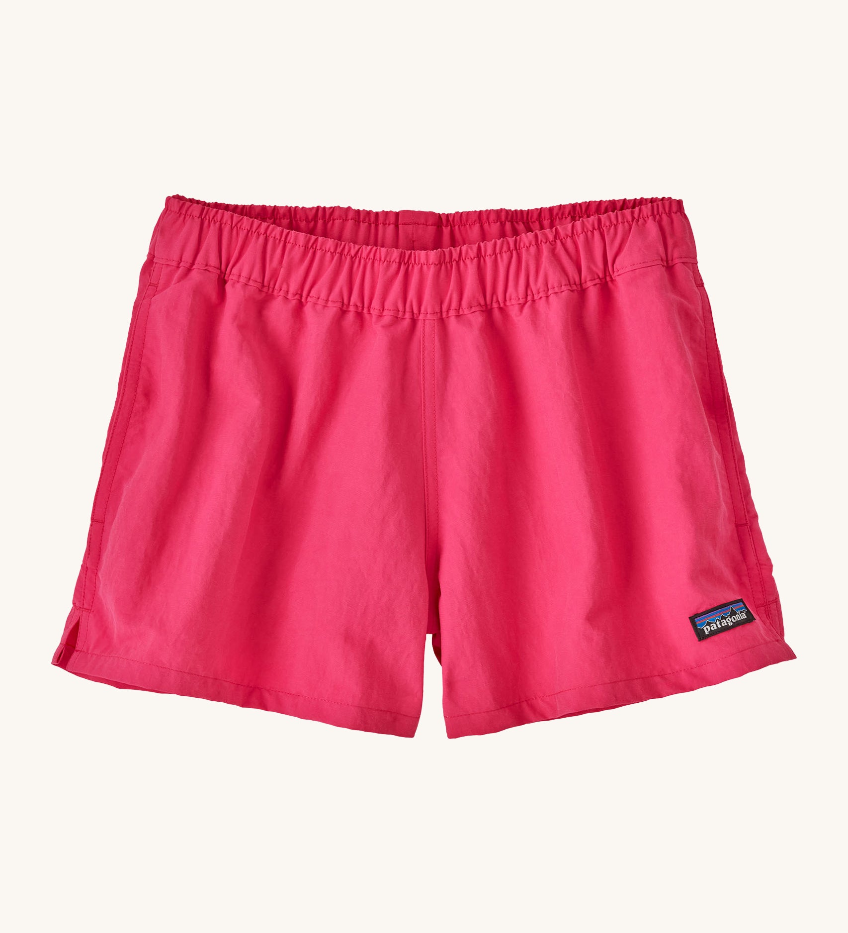 Patagonia women's barely baggies shorts in bright pink on a cream background.