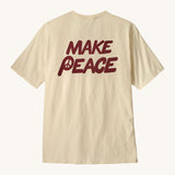 Patagonia men's balance organic top. A cream with short sleeves top showing the large 'make peace' slogan 