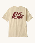 Patagonia men's balance organic top. A cream with short sleeves top showing the large 'make peace' slogan 