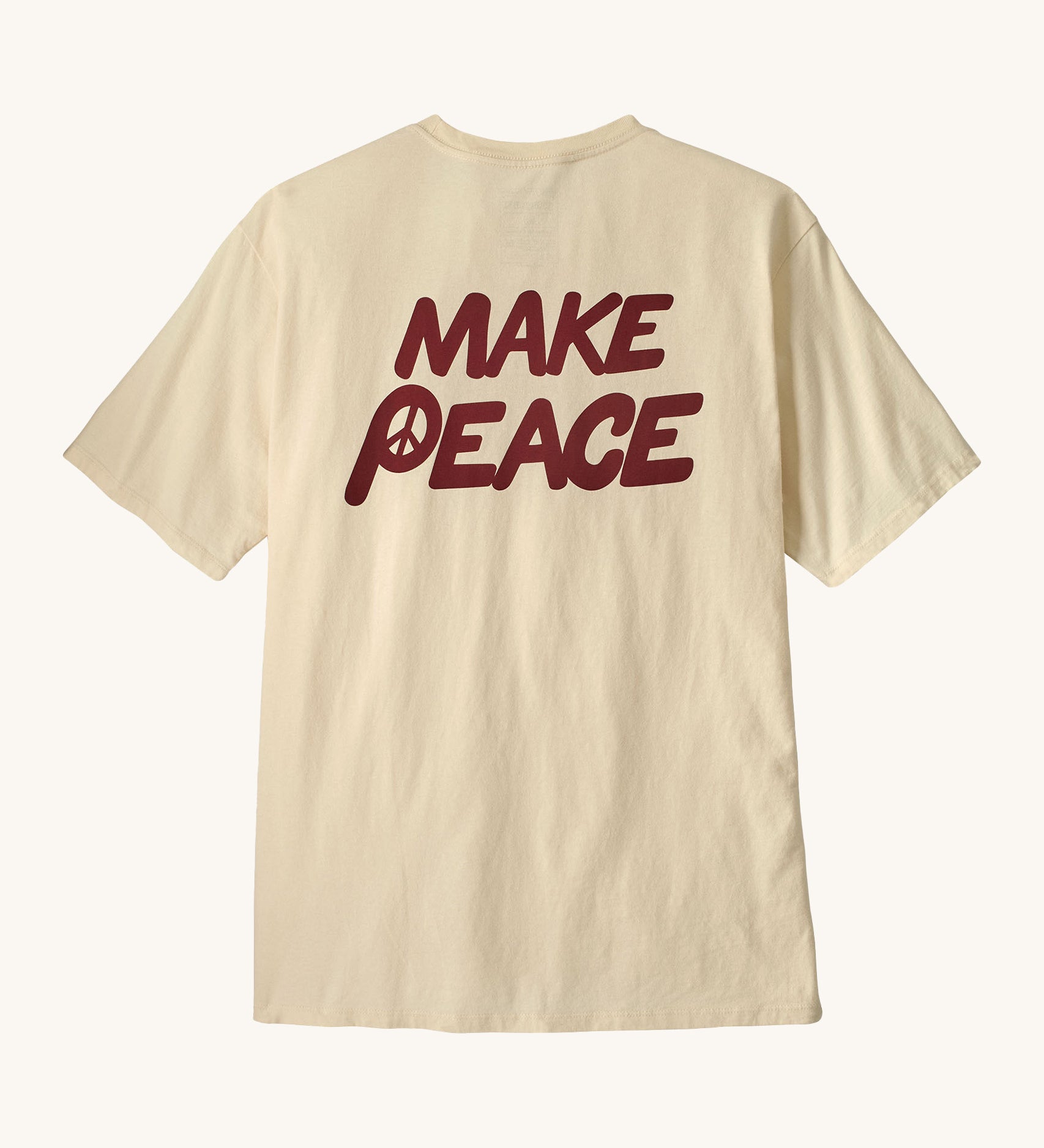 Patagonia men's balance organic top. A cream with short sleeves top showing the large 'make peace' slogan 