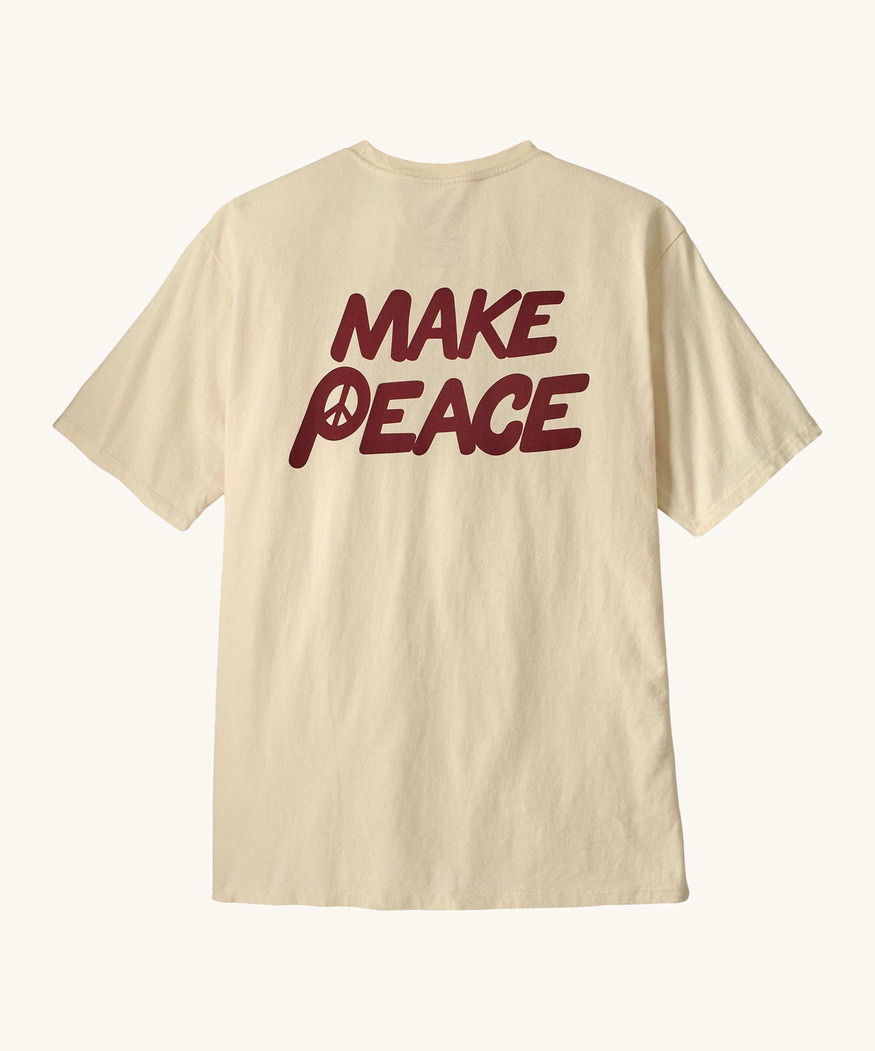 Patagonia men's balance organic top. A cream with short sleeves top showing the large 'make peace' slogan 