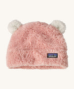 Patagonia little kids friends hat. A pink furry beanie to keep the head warm which features white bear-like ears on the top of the beanie. Features the logo patch stitched on the front side of the hat.