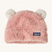 Patagonia little kids friends hat. A pink furry beanie to keep the head warm which features white bear-like ears on the top of the beanie. Features the logo patch stitched on the front side of the hat.