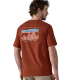 A man waering teh Patagonia Men's 73 Skyline Organic T-Shirt Burnished Red showing the back of the top