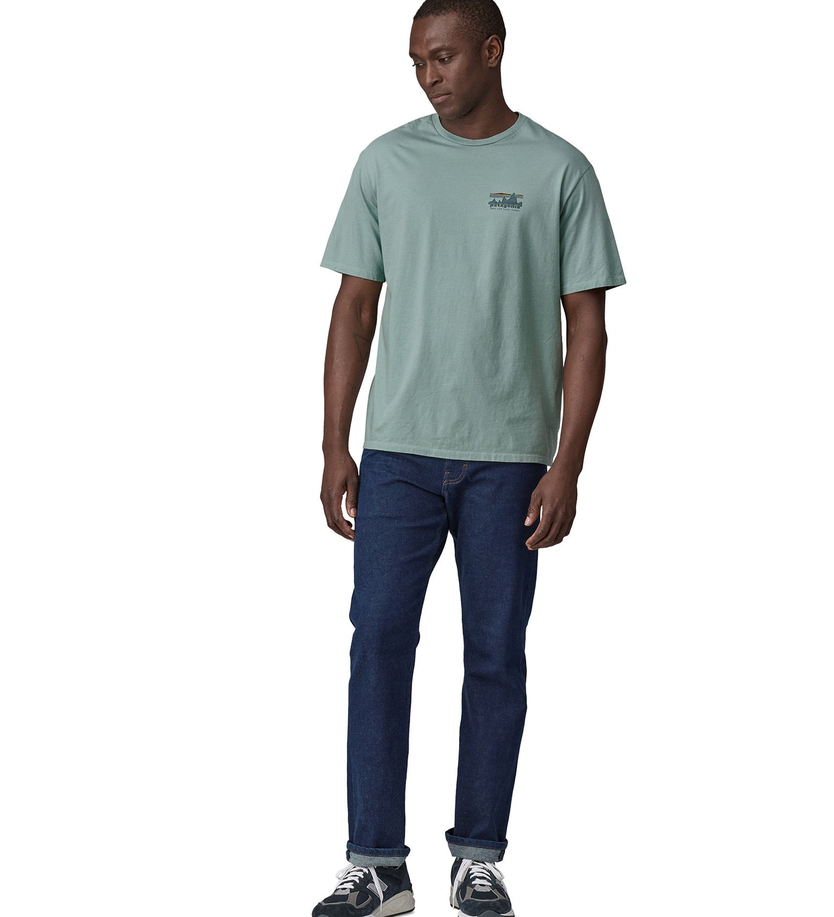 A man wearing the Patagonia Men's 73 Skyline Organic T-Shirt Thermal Blue