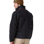 A man wearing a Patagonia Men's Classic Retro-X Jacket in a dark smolder blue colour, facing away from the camera, showing the back of the jacket..
