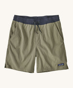 patagonia mens baggies shorts in a dark green colour on a cream background