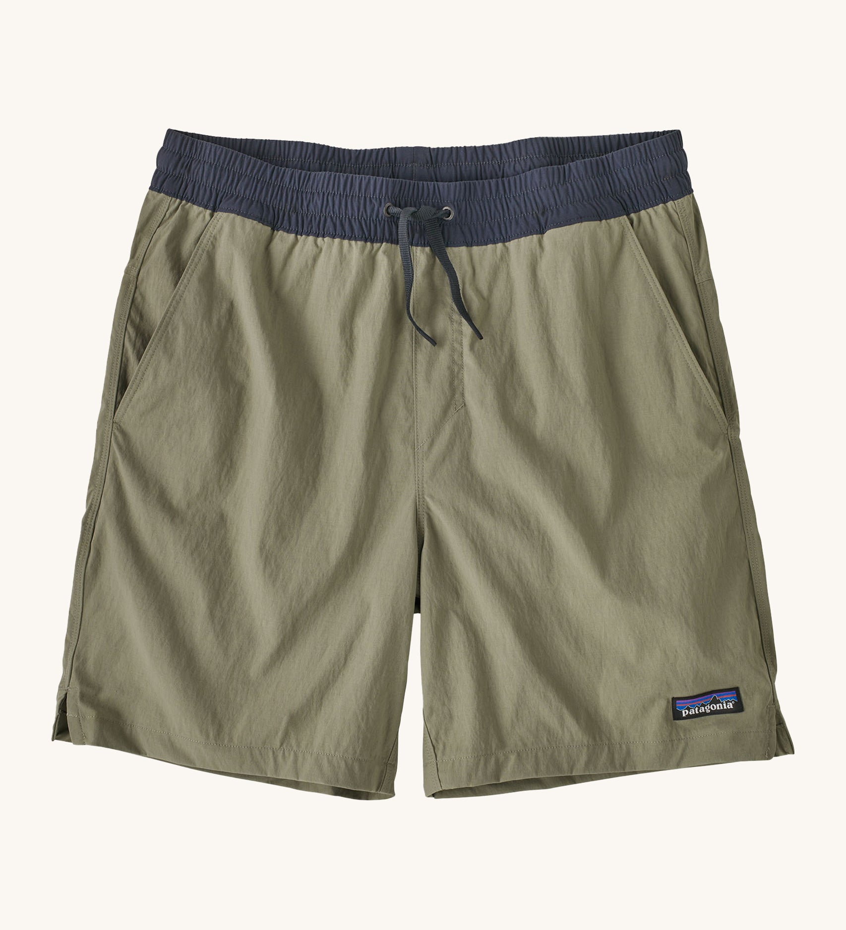 patagonia mens baggies shorts in a dark green colour on a cream background