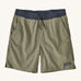 patagonia mens baggies shorts in a dark green colour on a cream background