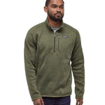A man wearing the Patagonia Men's Better Sweater quarter Zip Industrial Green