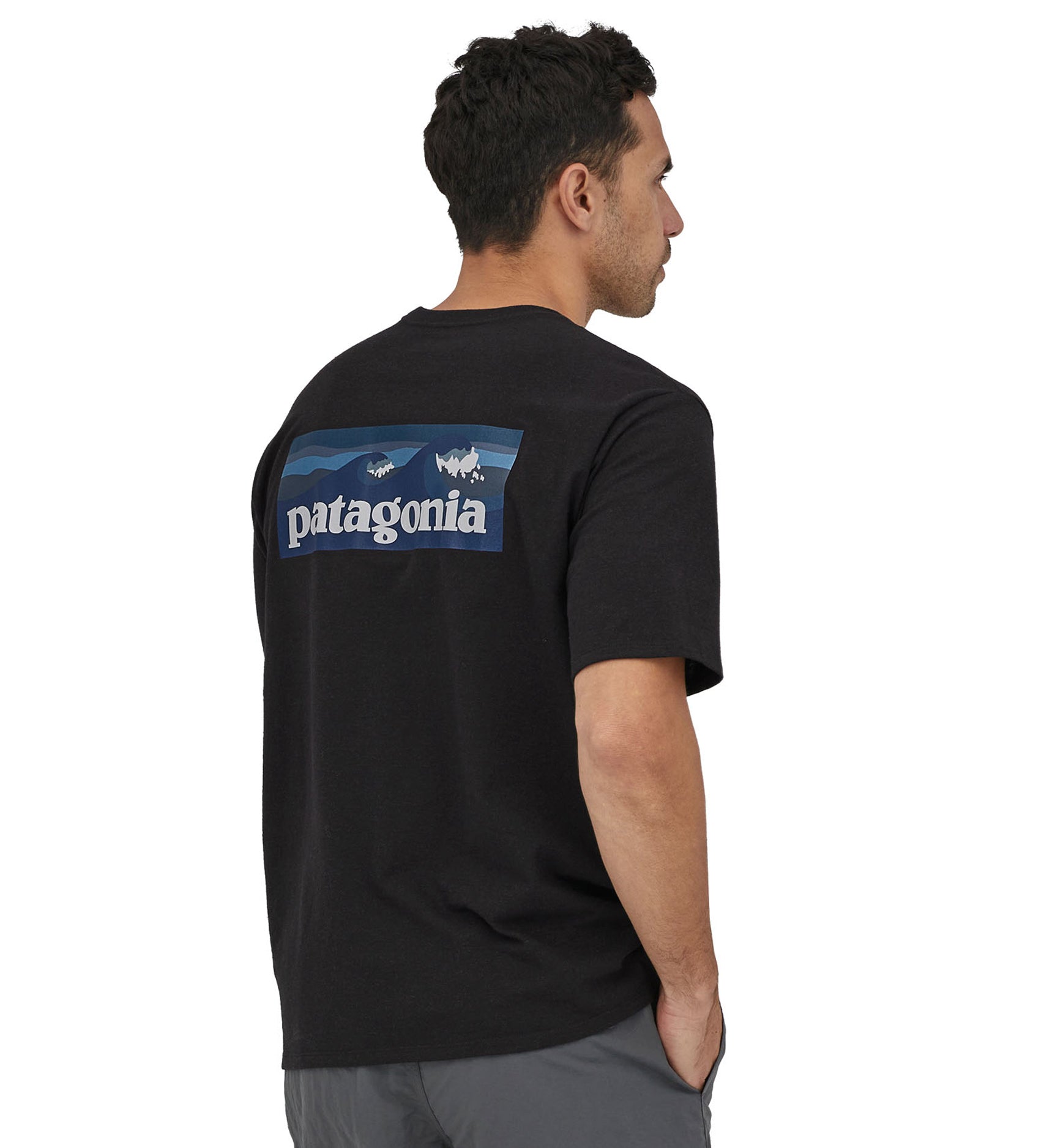 A man wearing a Patagonia Men's Boardshort Logo Pocket Responsibili-Tee Ink Black showing the back 