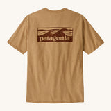 Patagonia men's boardshort logo top in talon gold. A pale gold colour t-shirt with short sleeve with a large branded print on the back. 