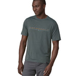 A man wearing a Patagonia Men's Cap Cool Daily Graphic Shirt in Nouveau Green