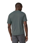 A man wearing a Patagonia Men's Cap Cool Daily Graphic Shirt in Nouveau Green showing the back of the t-shirt