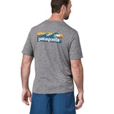 A man wearing a Patagonia Men's Capilene Cool Daily Graphic Shirt with a Waters / Feather Grey design, the man is facing away from the camera showing the back of the t-shirt. 